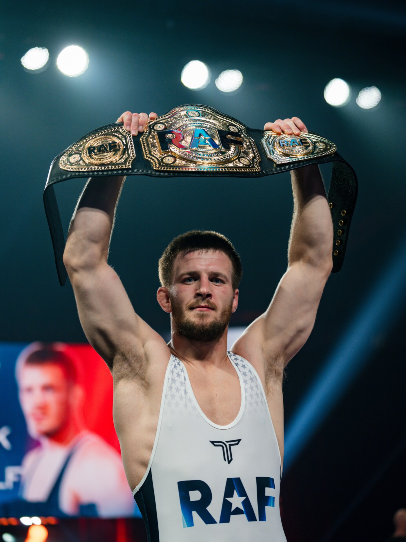 Jason Nolf holding a championship belt