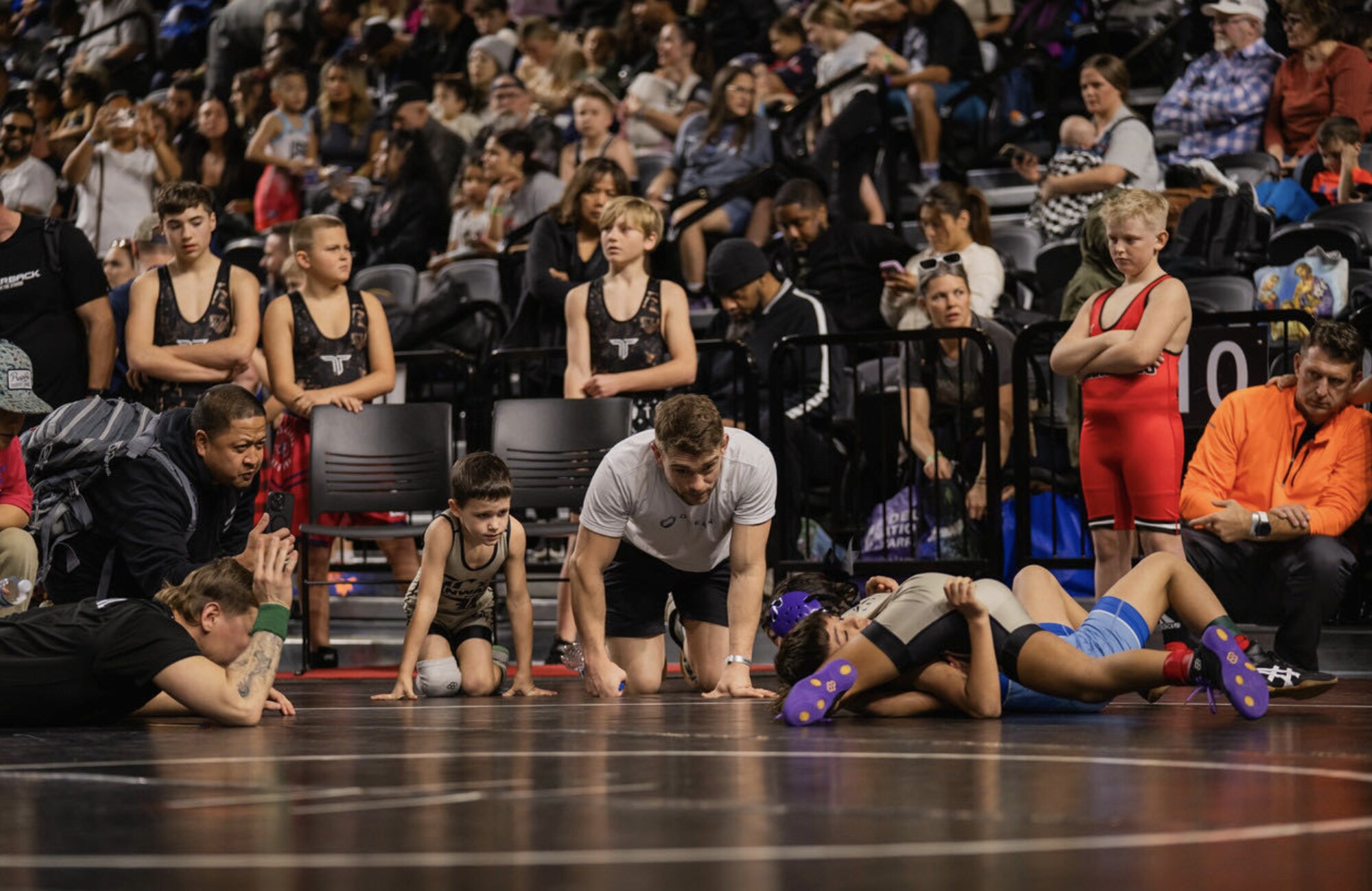 Jason Nolf coaching mat-side at a tournament
